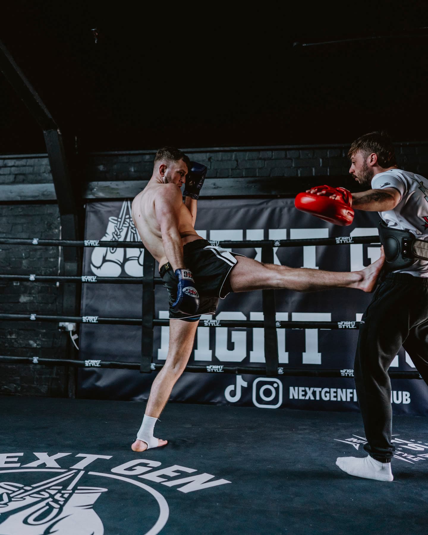 Hayden landing a high kick on the pads in the ring at Next Gen Fight Hub