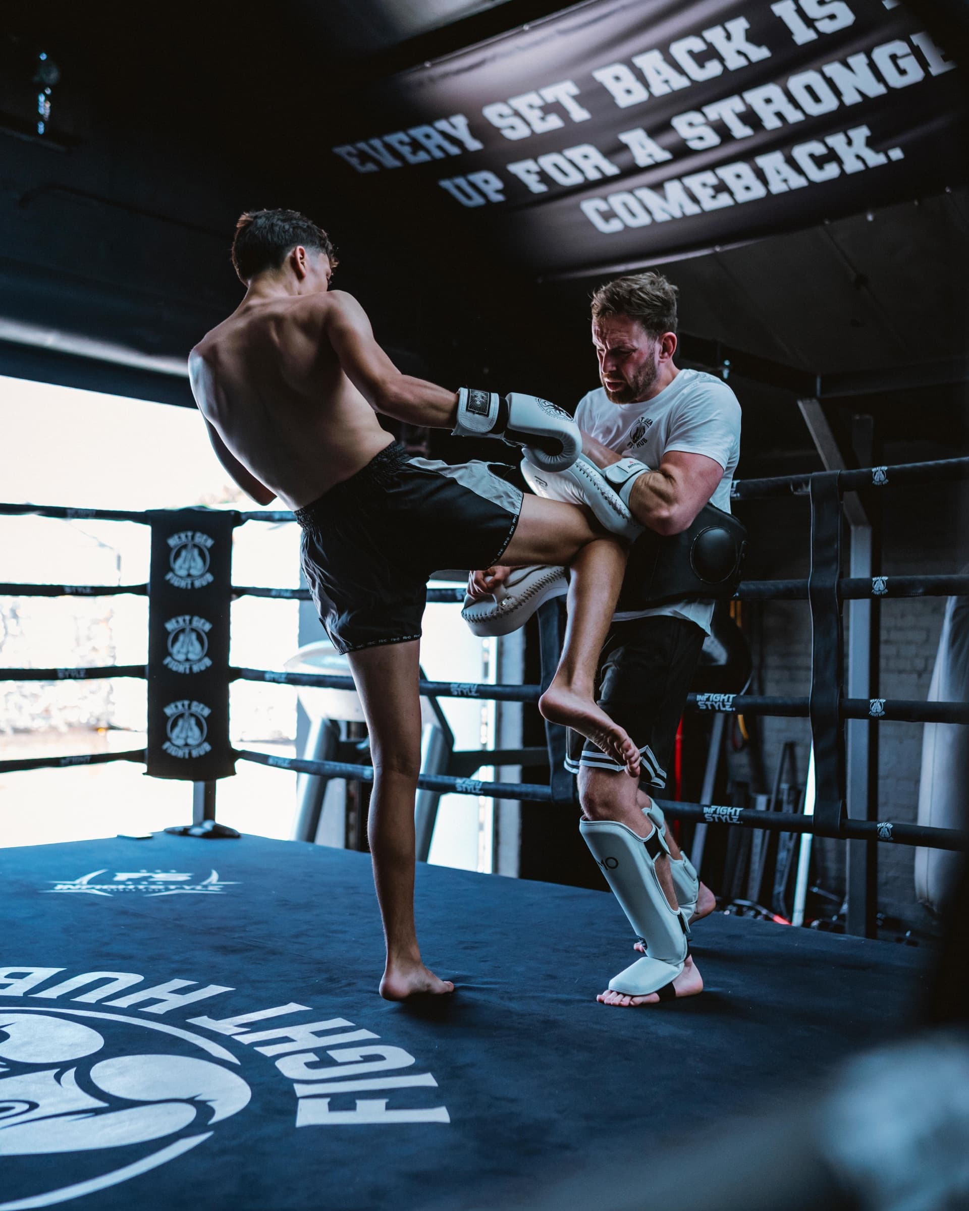 Hayden catching a body kick on the pads on the ring apron at Next Gen Fight Hub