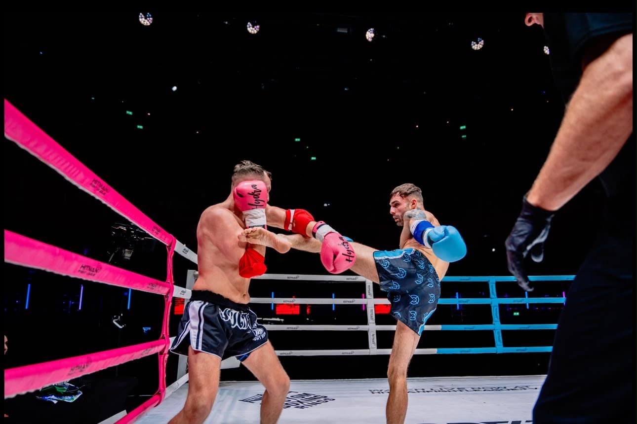 Hayden covering against a kick on the ropes at the Hitman Fight League